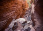 Hole-in-the-Rock crevice mid section -- Here passage was too narrow for a wagon. Rock fill (now washed away) was used to raise the bottom of the crevice by as much as eight feet. Lamont Crabtree Photo  